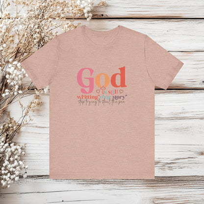 God Is Still Writing Your Story – Inspirational Christian T-Shirt | Unisex Jersey Short Sleeve Tee